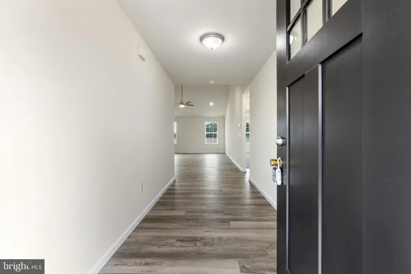a view of hallway with wooden floor