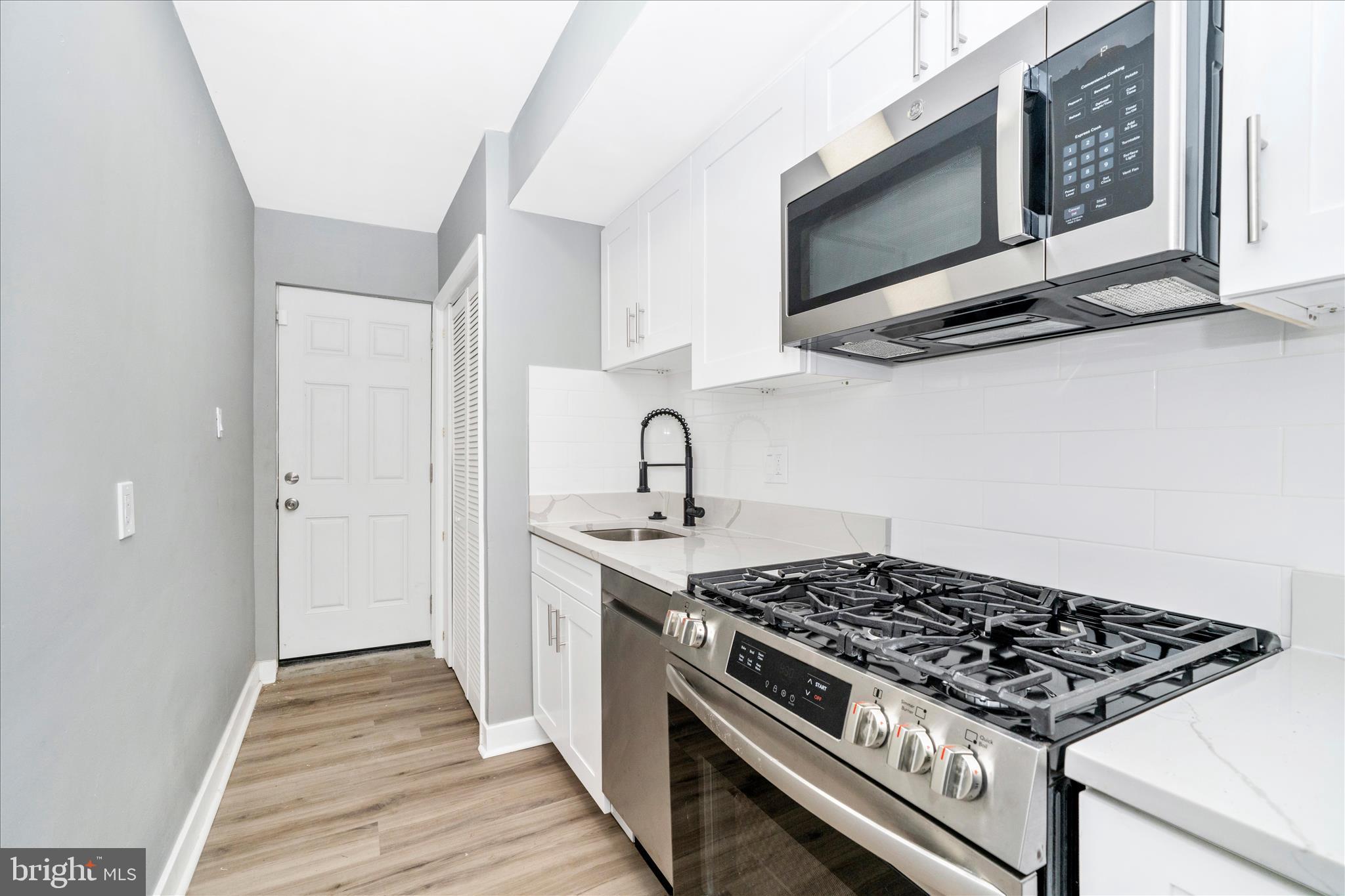 5027 Benning Road Southeast Washington, DC 20019 - Photo 18 of 57 a stove top oven sitting inside of a kitchen