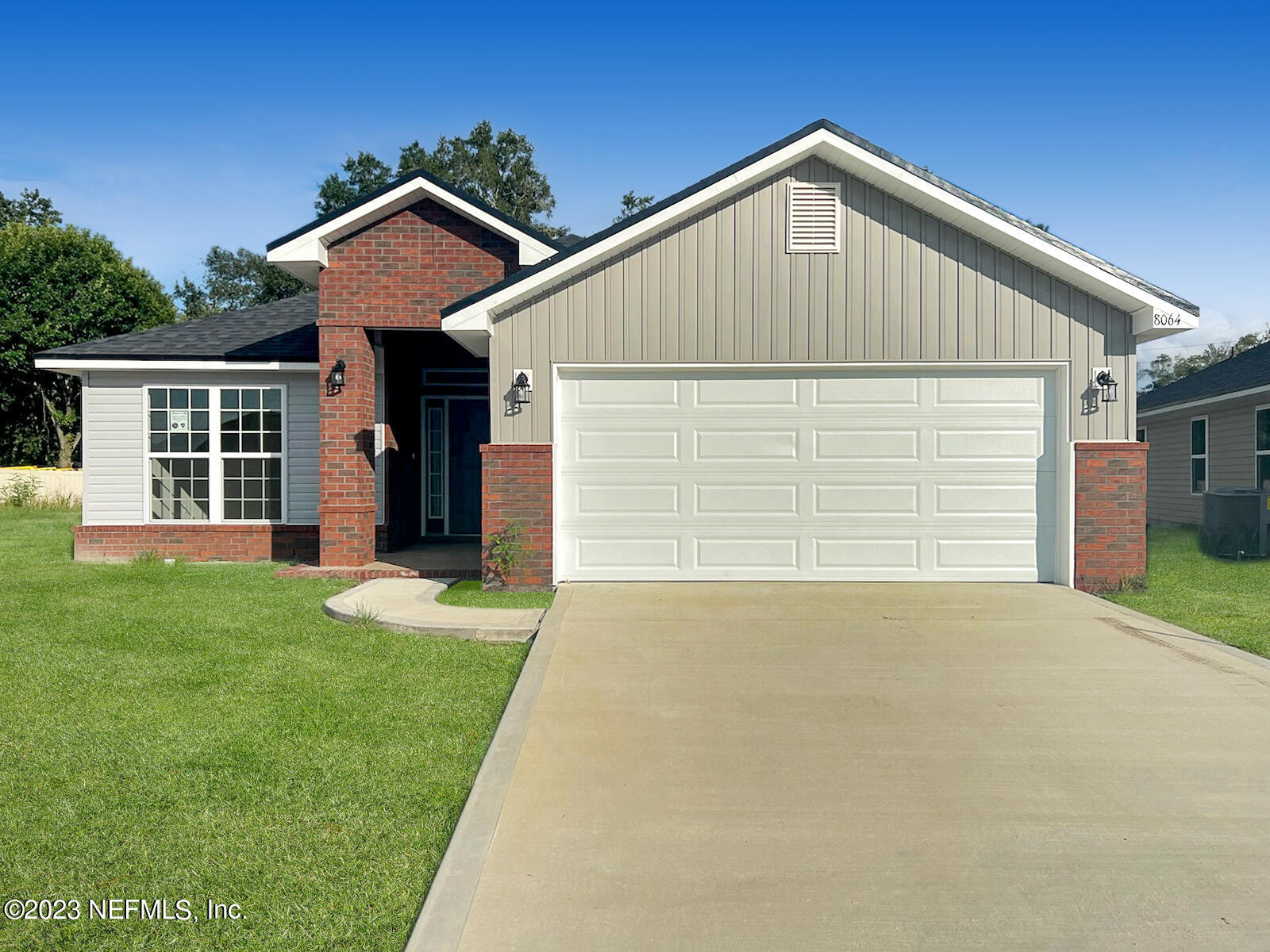 7833 Driggers Street Jacksonville, FL 32220 - Photo 1 of 26 a front view of a house with a yard and garage