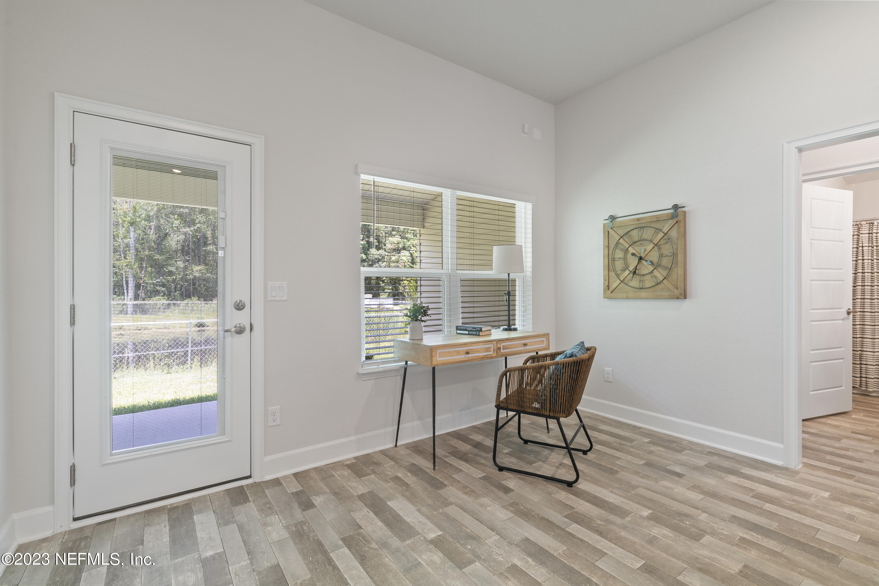 7833 Driggers Street Jacksonville, FL 32220 - Photo 12 of 26 a view of a workspace with furniture and a window