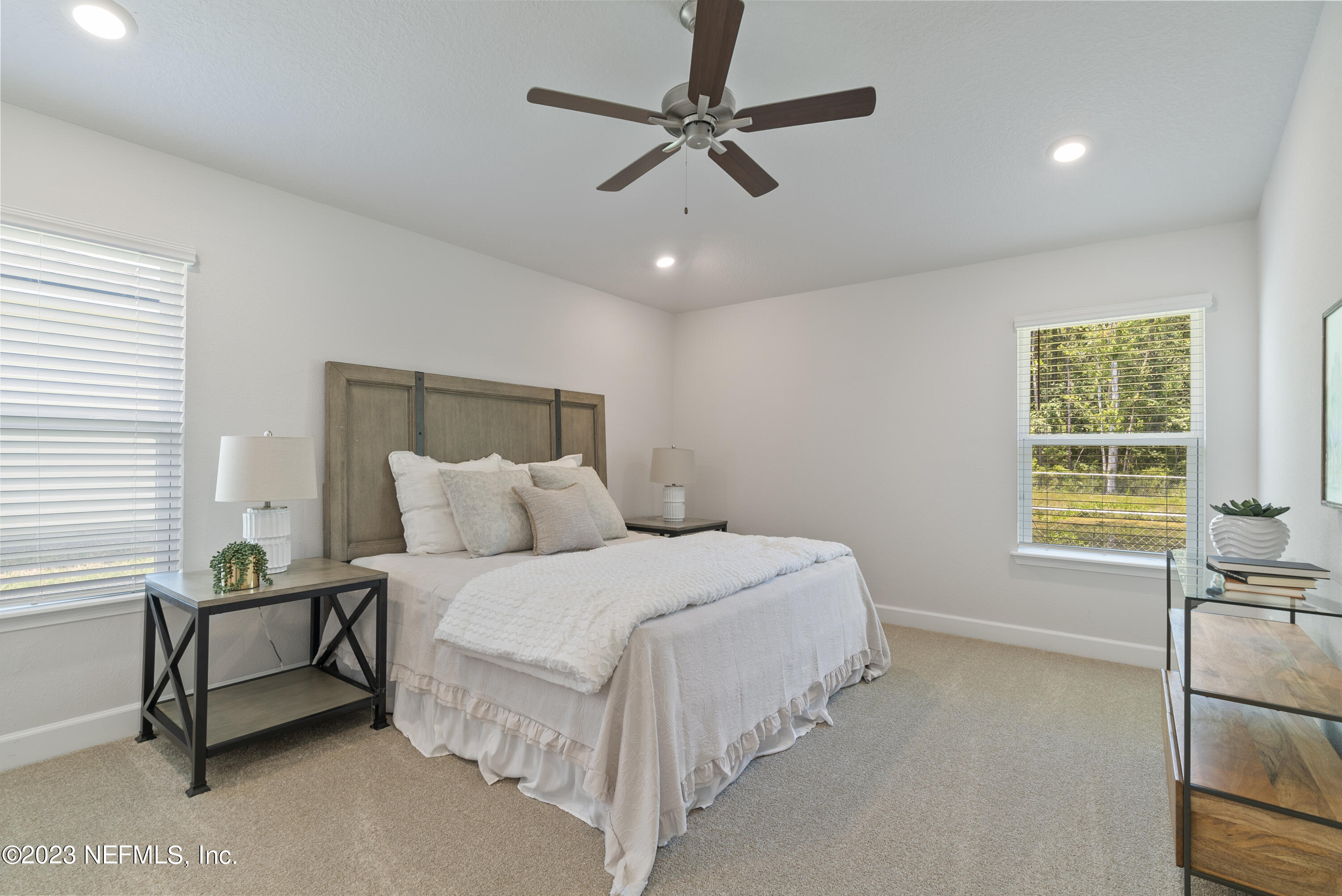 7833 Driggers Street Jacksonville, FL 32220 - Photo 13 of 26 a bedroom with a bed a desk and chair