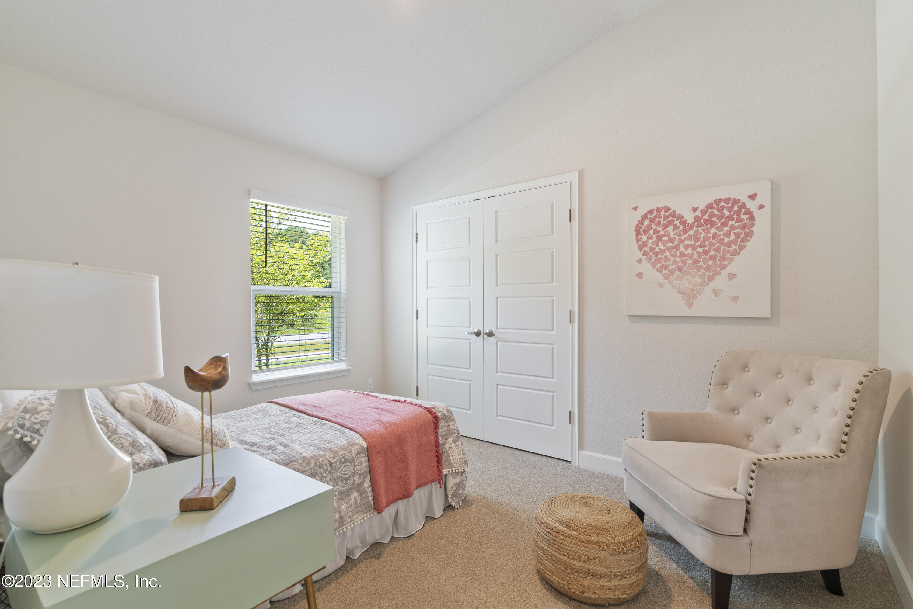 7833 Driggers Street Jacksonville, FL 32220 - Photo 18 of 26 a bedroom with a bed and a couch