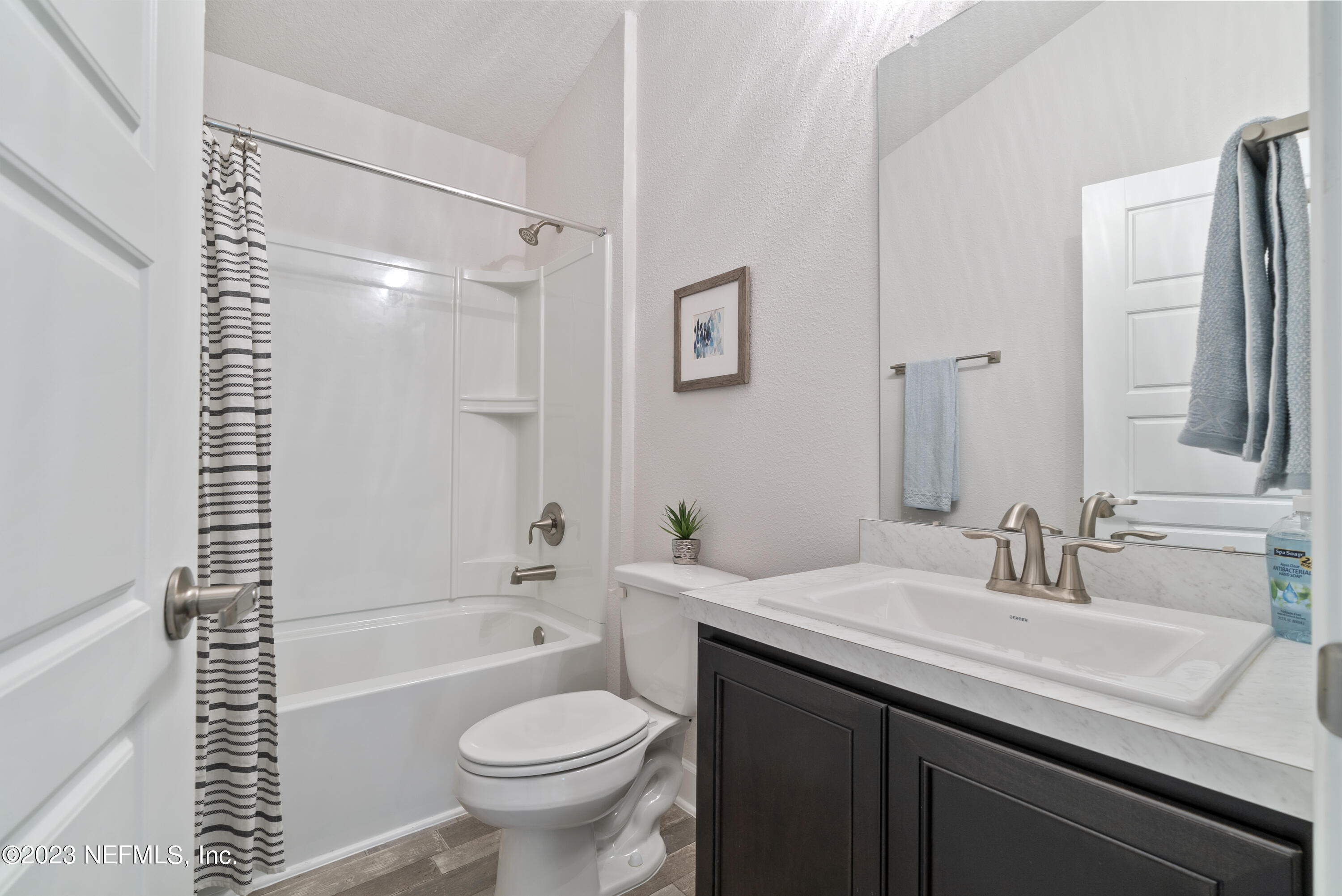 7833 Driggers Street Jacksonville, FL 32220 - Photo 19 of 26 a bathroom with a sink a toilet and a bathtub