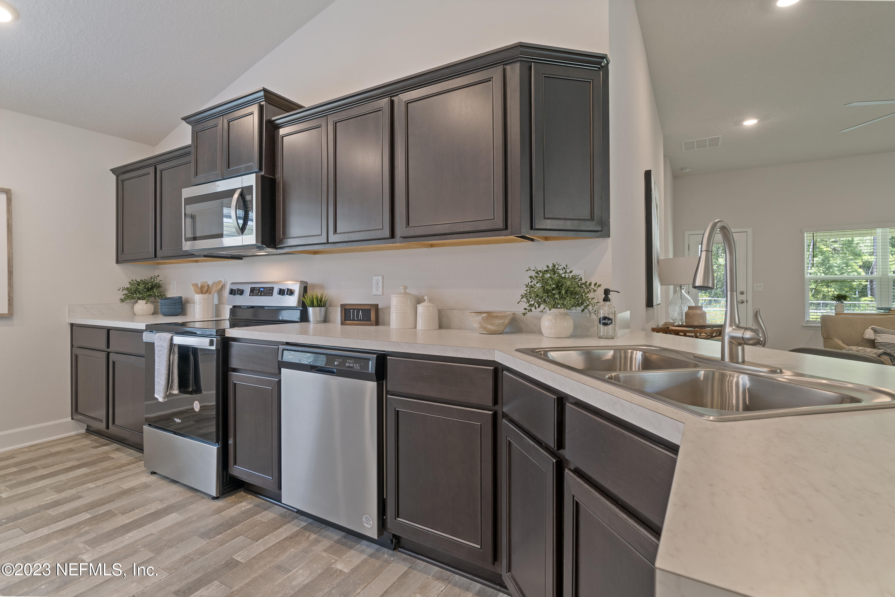 7833 Driggers Street Jacksonville, FL 32220 - Photo 3 of 26 a kitchen with a sink cabinets and stainless steel appliances
