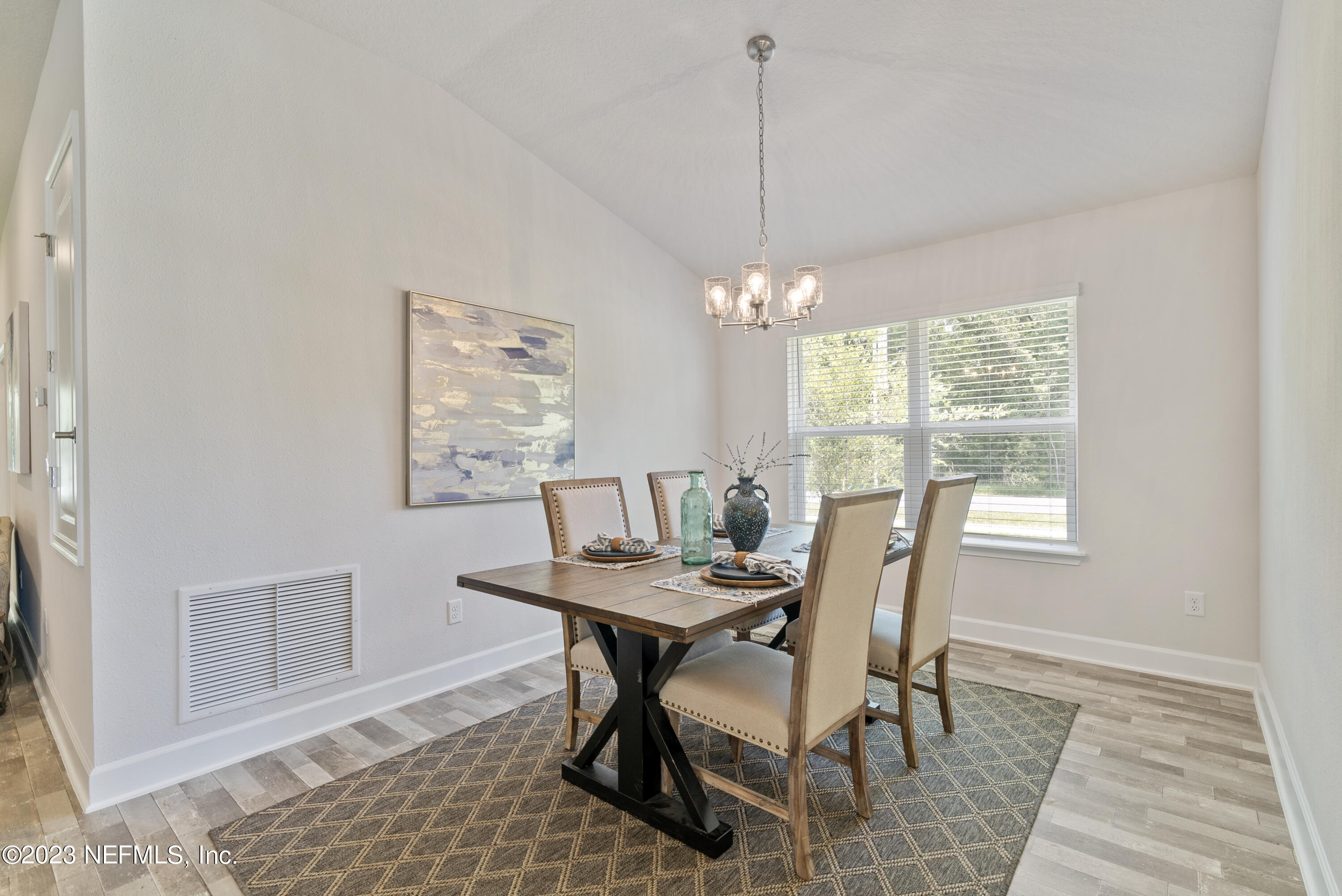 7833 Driggers Street Jacksonville, FL 32220 - Photo 8 of 26 a view of a dining room with furniture window and wooden floor