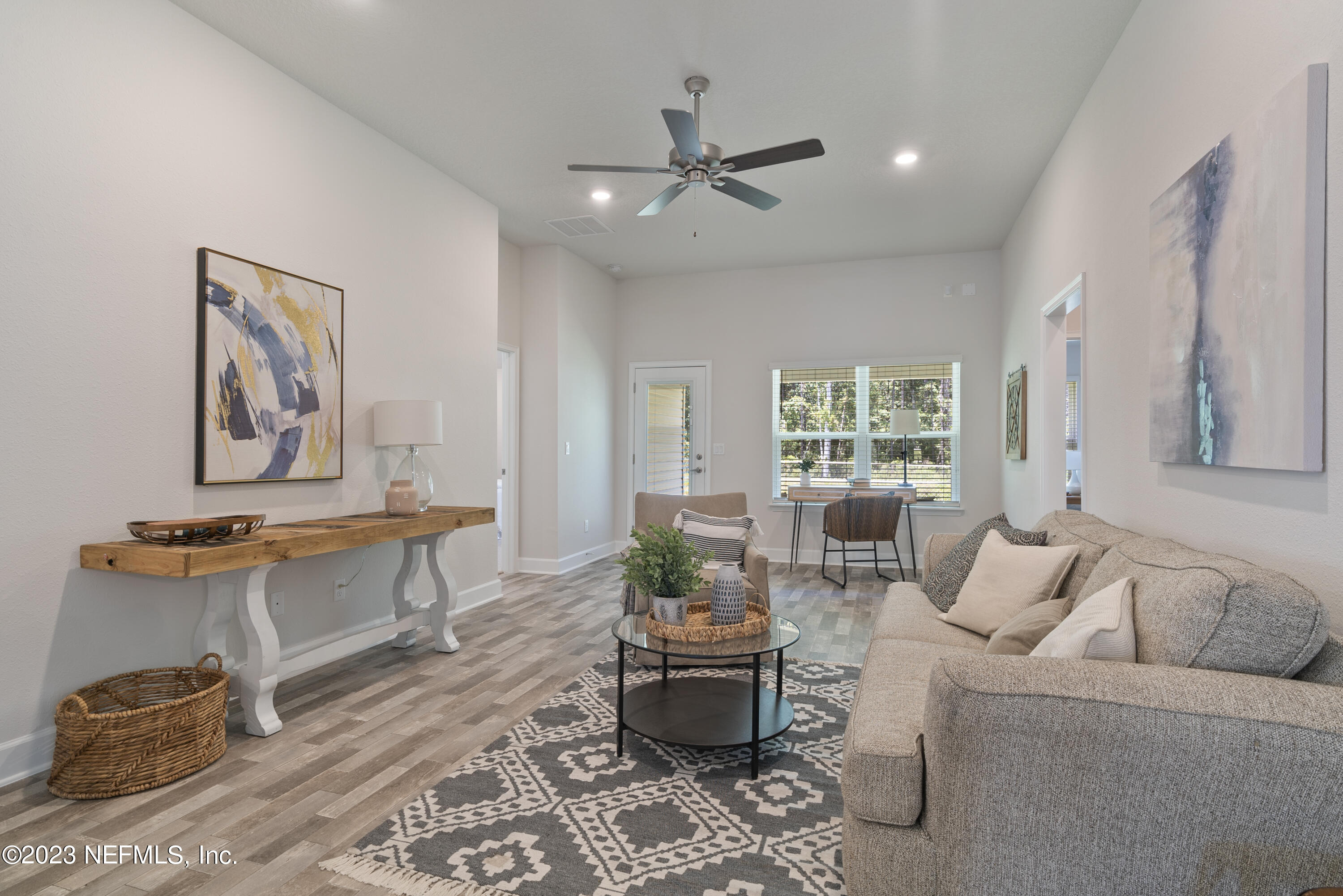 7833 Driggers Street Jacksonville, FL 32220 - Photo 10 of 26 a living room with furniture and wooden floor