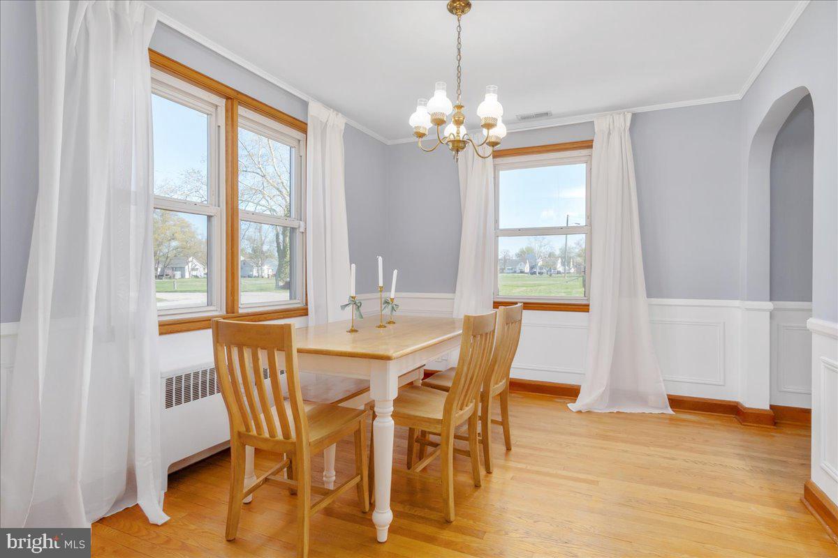 8466 Greenway Road Pasadena, MD 21122 - Photo 14 of 56 a view of a dining room with furniture wooden floor and chandelier