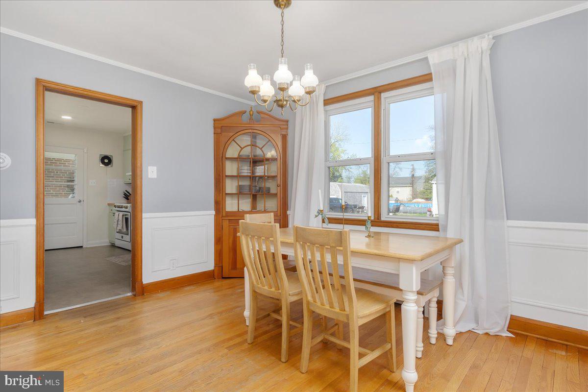 8466 Greenway Road Pasadena, MD 21122 - Photo 15 of 56 a view of a dining room with furniture and a chandelier
