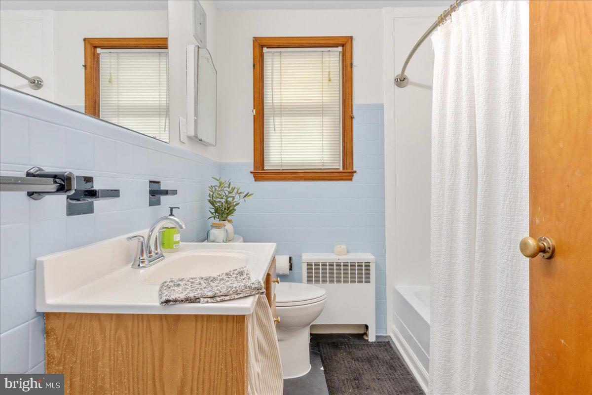8466 Greenway Road Pasadena, MD 21122 - Photo 17 of 56 a bathroom with a sink a toilet and a mirror