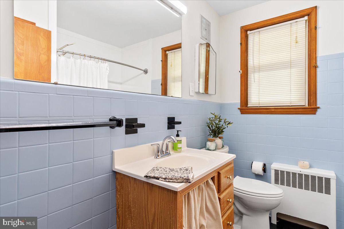 8466 Greenway Road Pasadena, MD 21122 - Photo 18 of 56 a bathroom with a granite countertop sink and a toilet