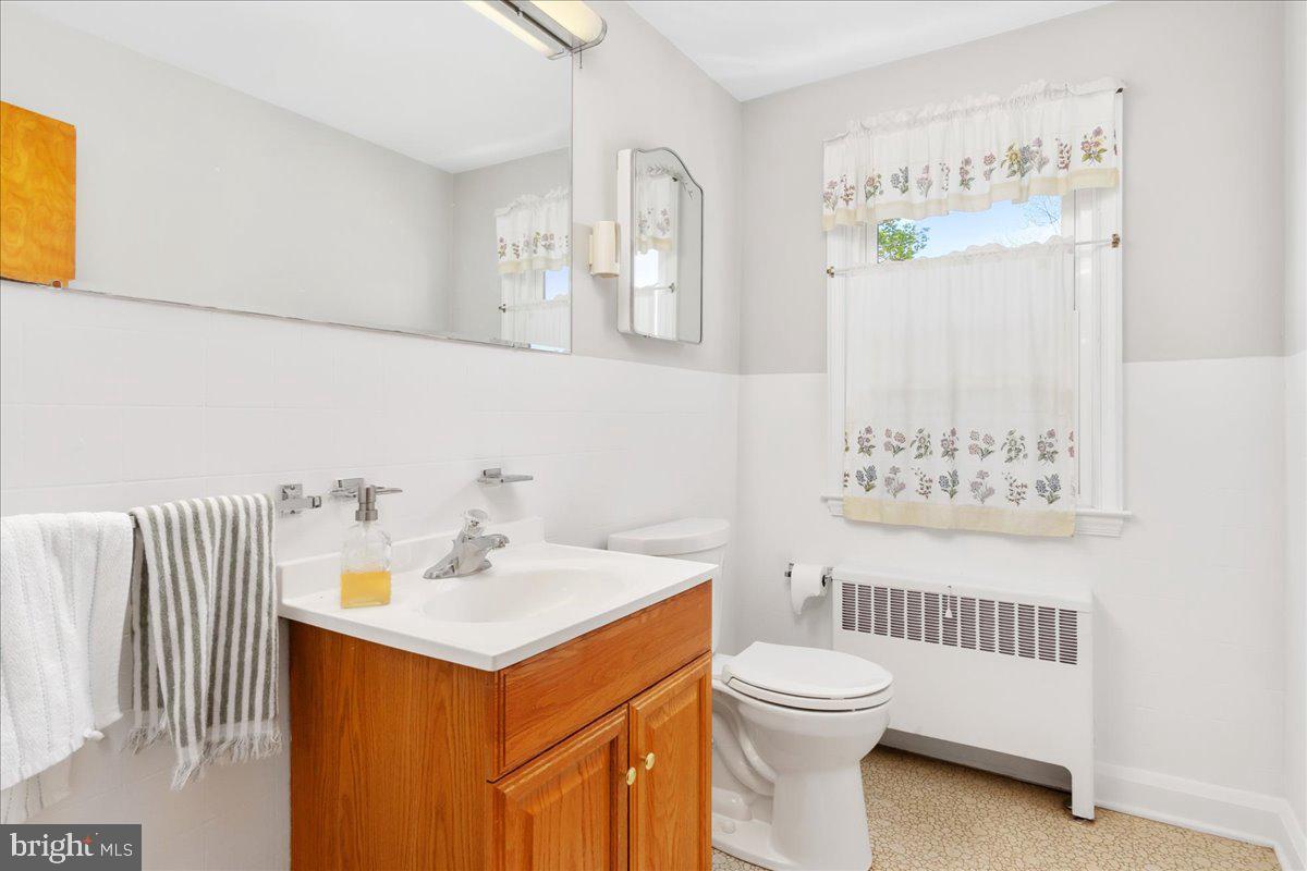 8466 Greenway Road Pasadena, MD 21122 - Photo 24 of 56 a bathroom with a sink a toilet and a mirror