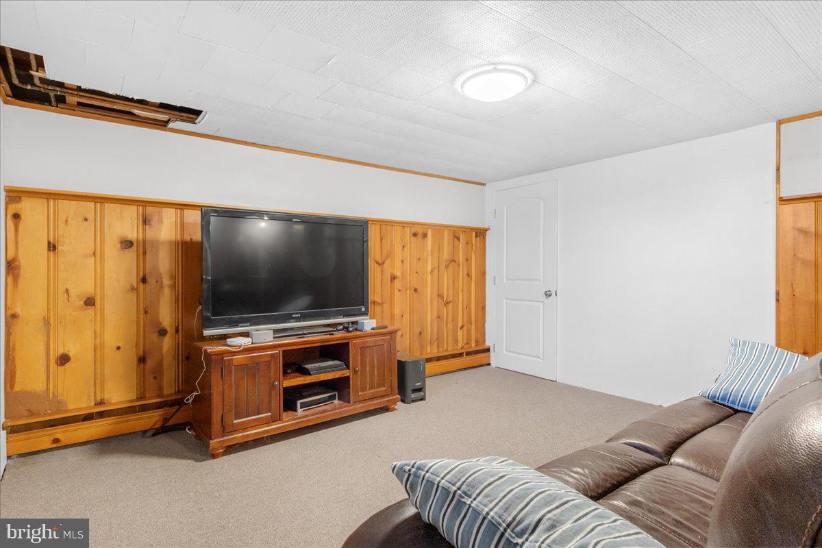 8466 Greenway Road Pasadena, MD 21122 - Photo 28 of 56 a living room with furniture and a flat screen tv