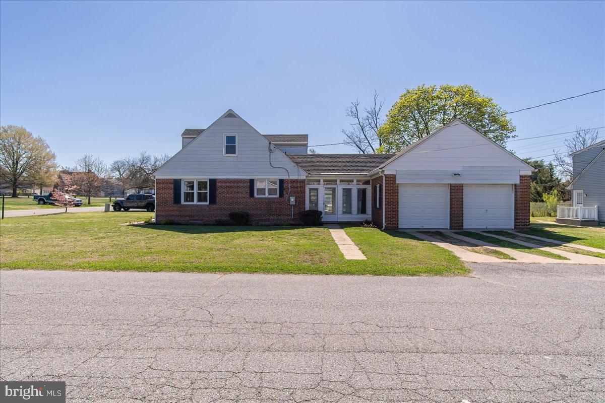 8466 Greenway Road Pasadena, MD 21122 - Photo 3 of 56 a front view of a house with a yard and garage