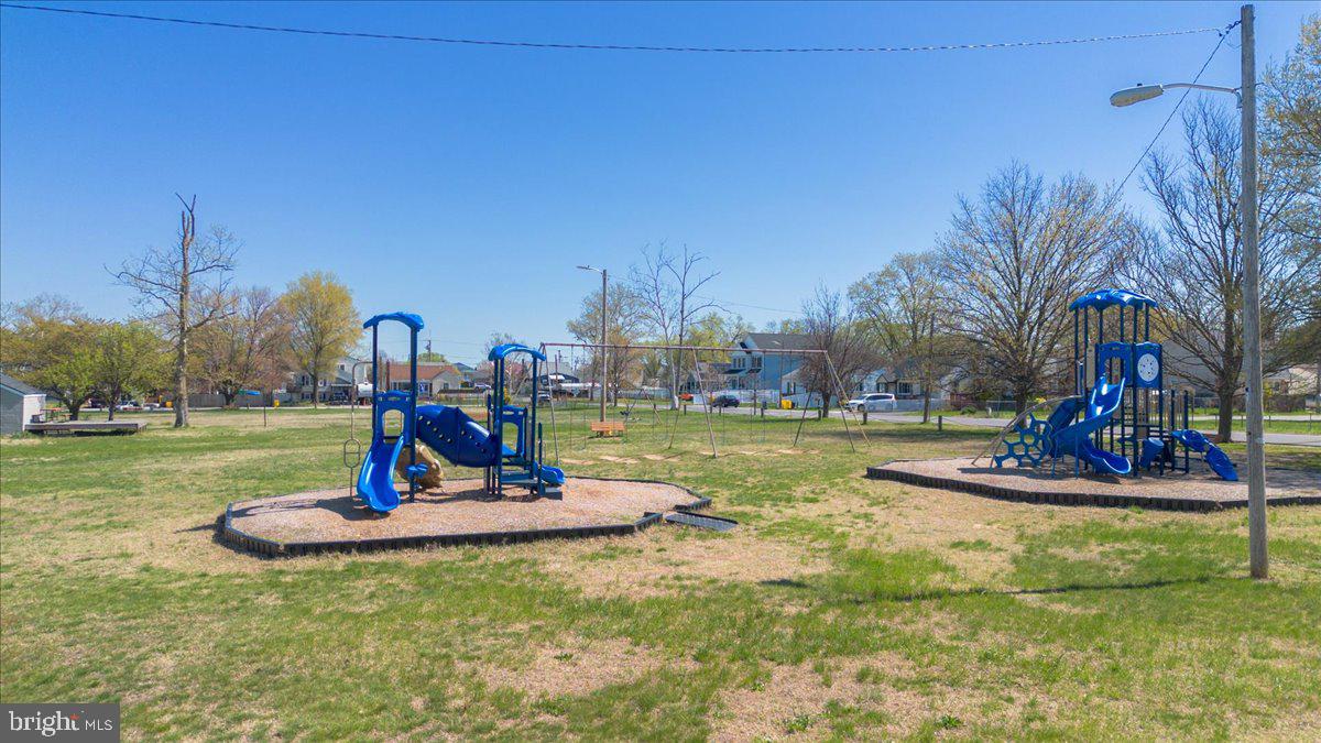 8466 Greenway Road Pasadena, MD 21122 - Photo 41 of 56 a view of a park with swings and a fountain