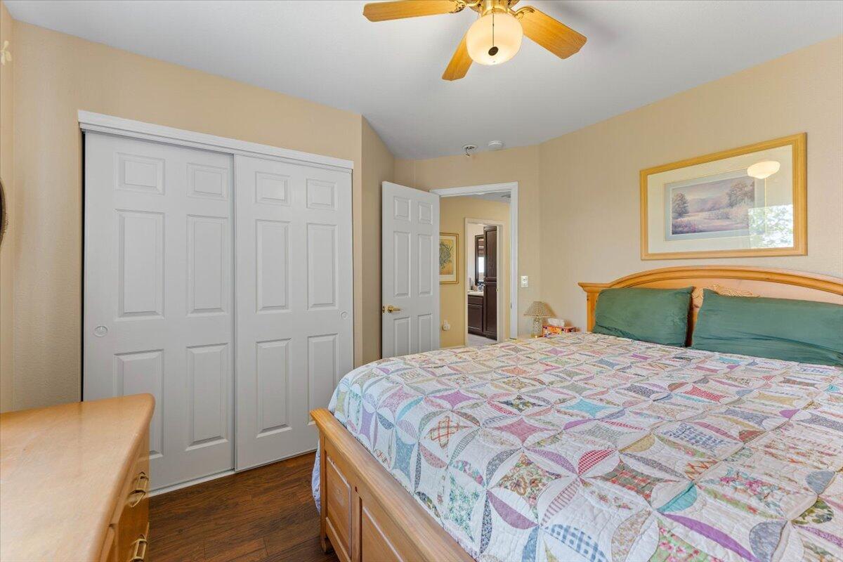 20410 Mallorca Lane Red Bluff, CA 96080 - Photo 19 of 37 a bedroom with a bed and a chandelier