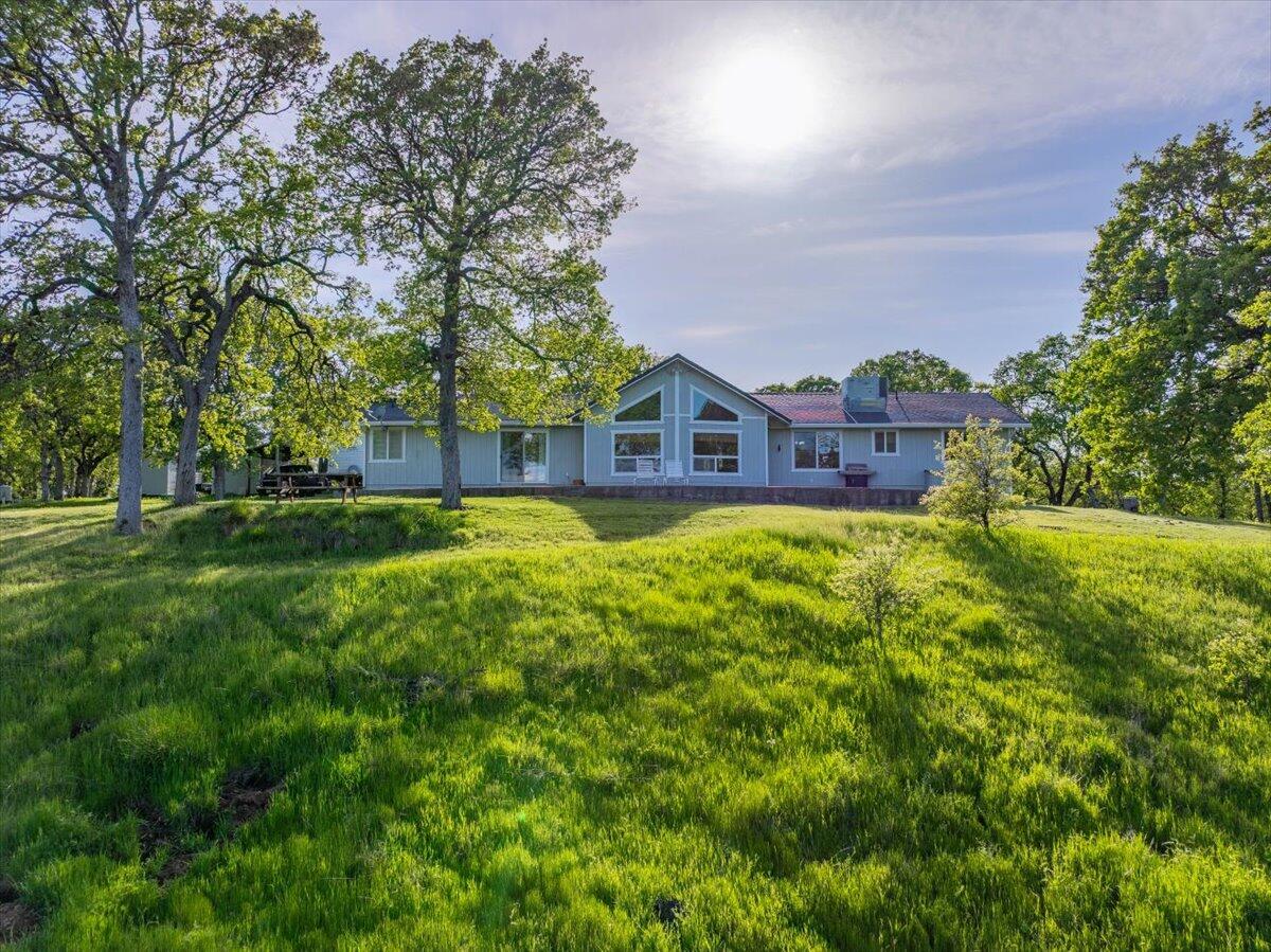 20410 Mallorca Lane Red Bluff, CA 96080 - Photo 27 of 37 a view of a house with a big yard and large trees