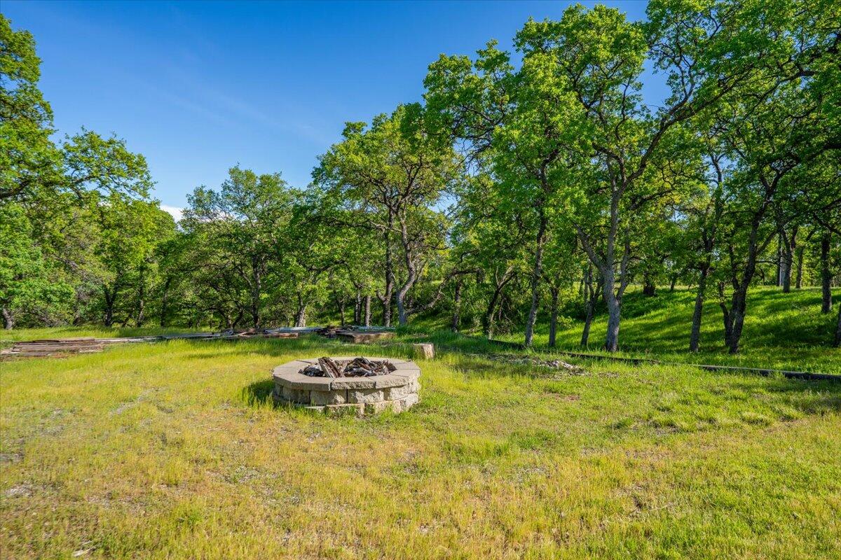 20410 Mallorca Lane Red Bluff, CA 96080 - Photo 31 of 37 a swimming pool with lawn chairs and wooden fence