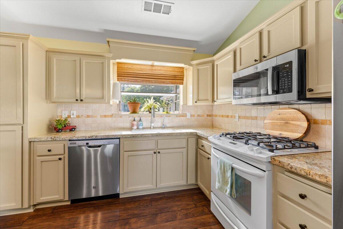 20410 Mallorca Lane Red Bluff, CA 96080 - Photo 5 of 37 a kitchen with granite countertop cabinets stainless steel appliances and a sink