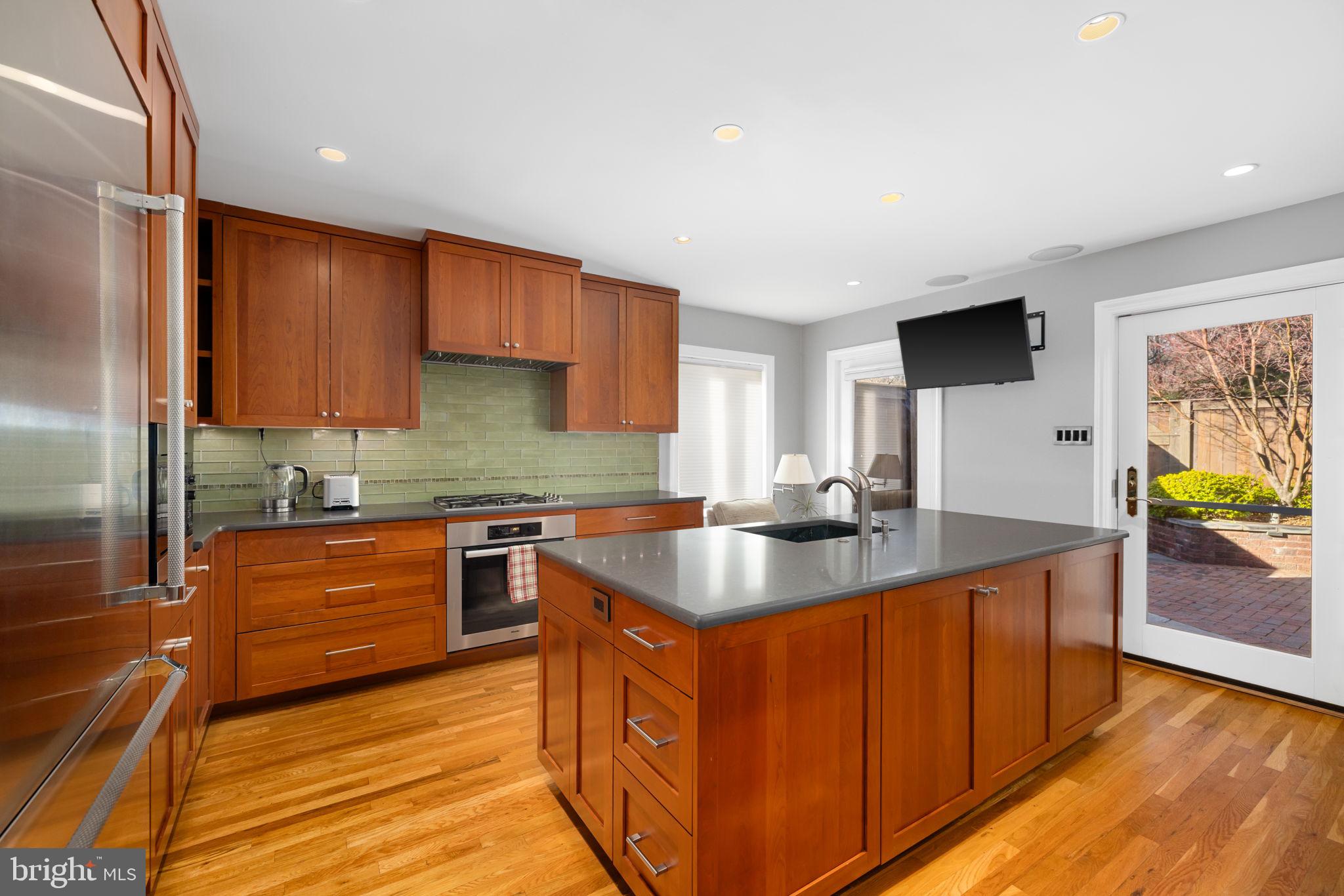 3988 Georgetown Court Northwest Washington, DC 20007 - Photo 13 of 38 a kitchen with stainless steel appliances granite countertop a sink stove and refrigerator
