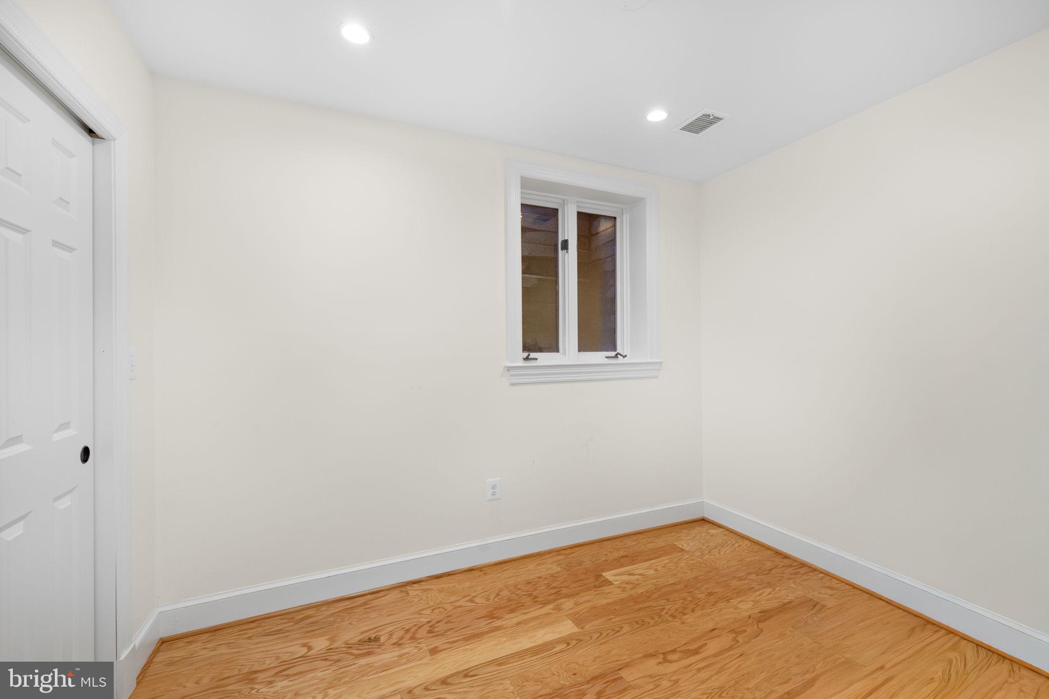 3988 Georgetown Court Northwest Washington, DC 20007 - Photo 30 of 38 a view of a room with wooden floor and white walls