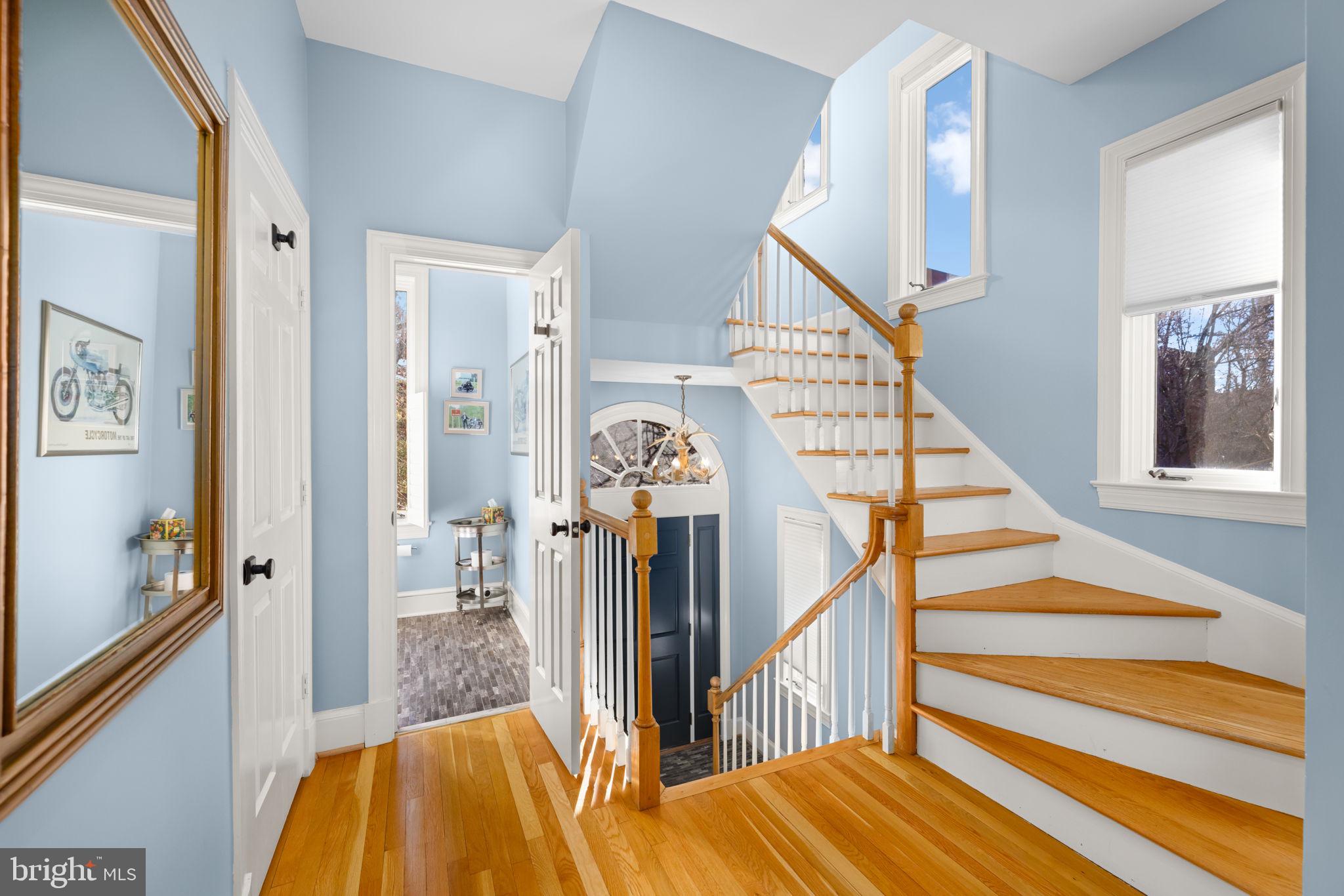 3988 Georgetown Court Northwest Washington, DC 20007 - Photo 3 of 38 a view of a hallway with wooden floor and stairs