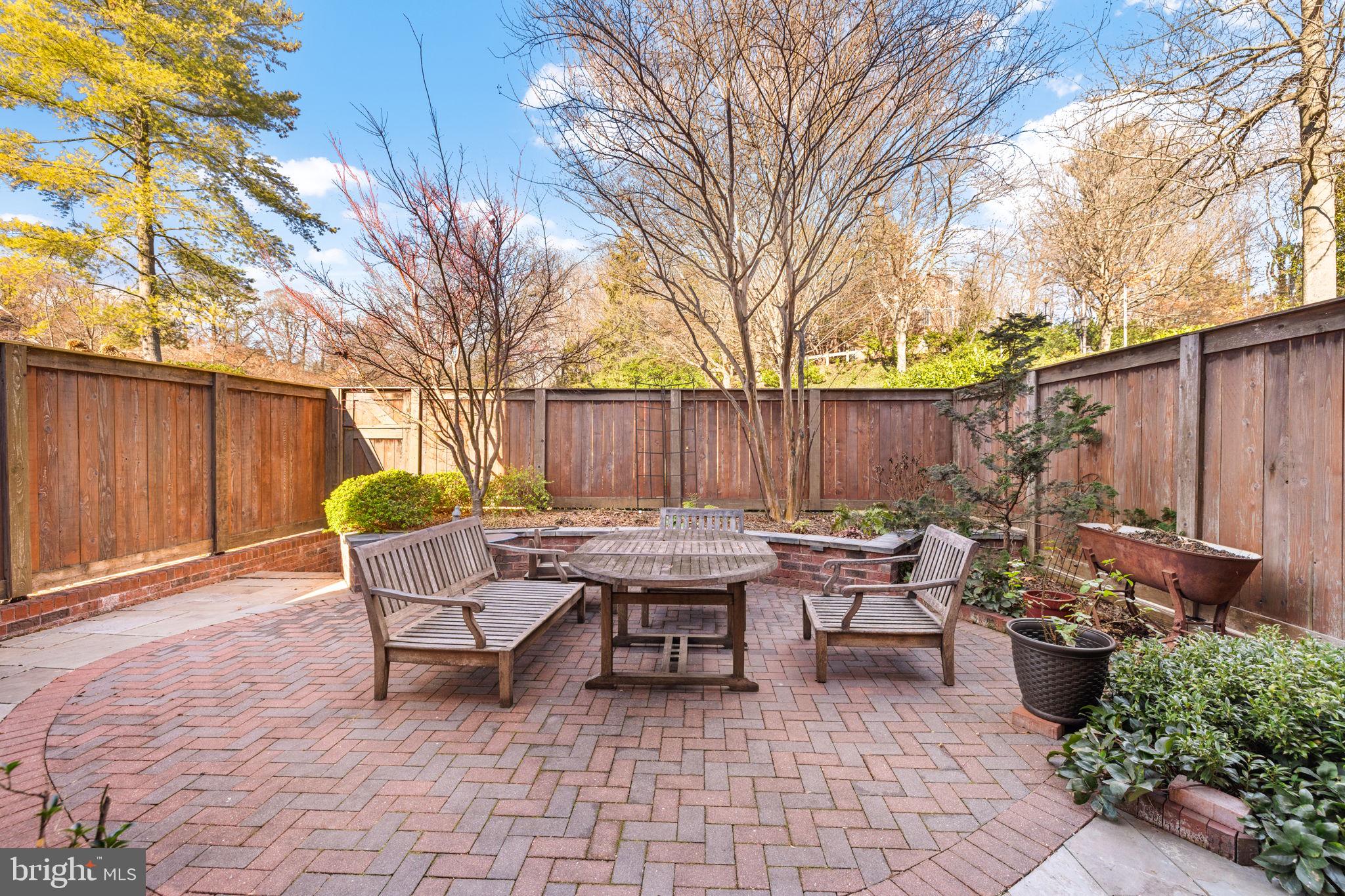 3988 Georgetown Court Northwest Washington, DC 20007 - Photo 33 of 38 a backyard of a house with fountain table and chairs