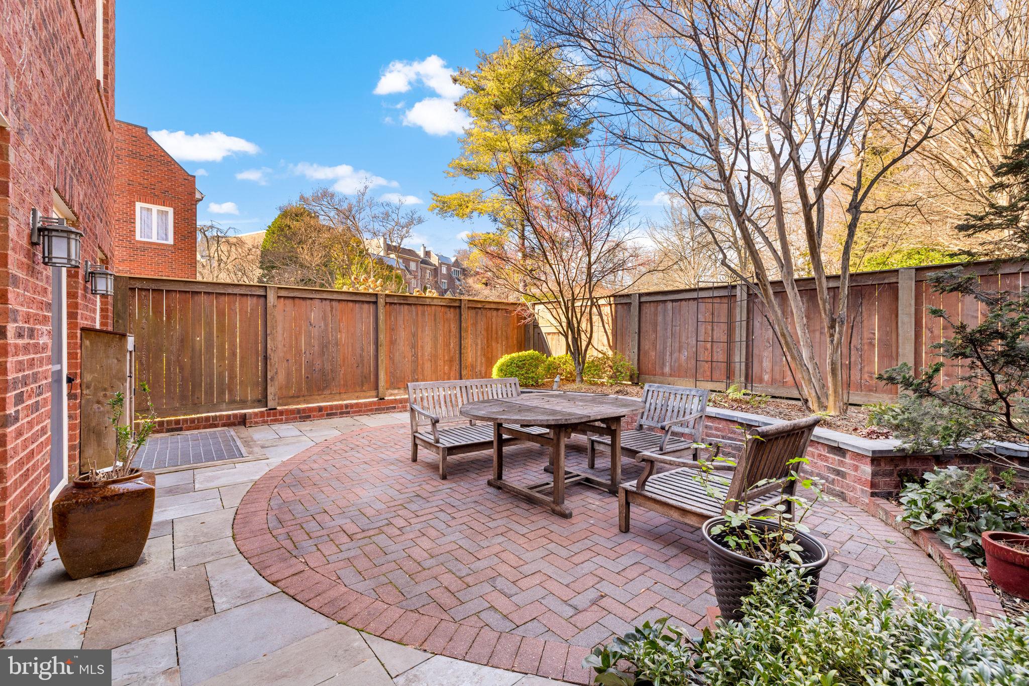 3988 Georgetown Court Northwest Washington, DC 20007 - Photo 34 of 38 a backyard of a house with table and chairs