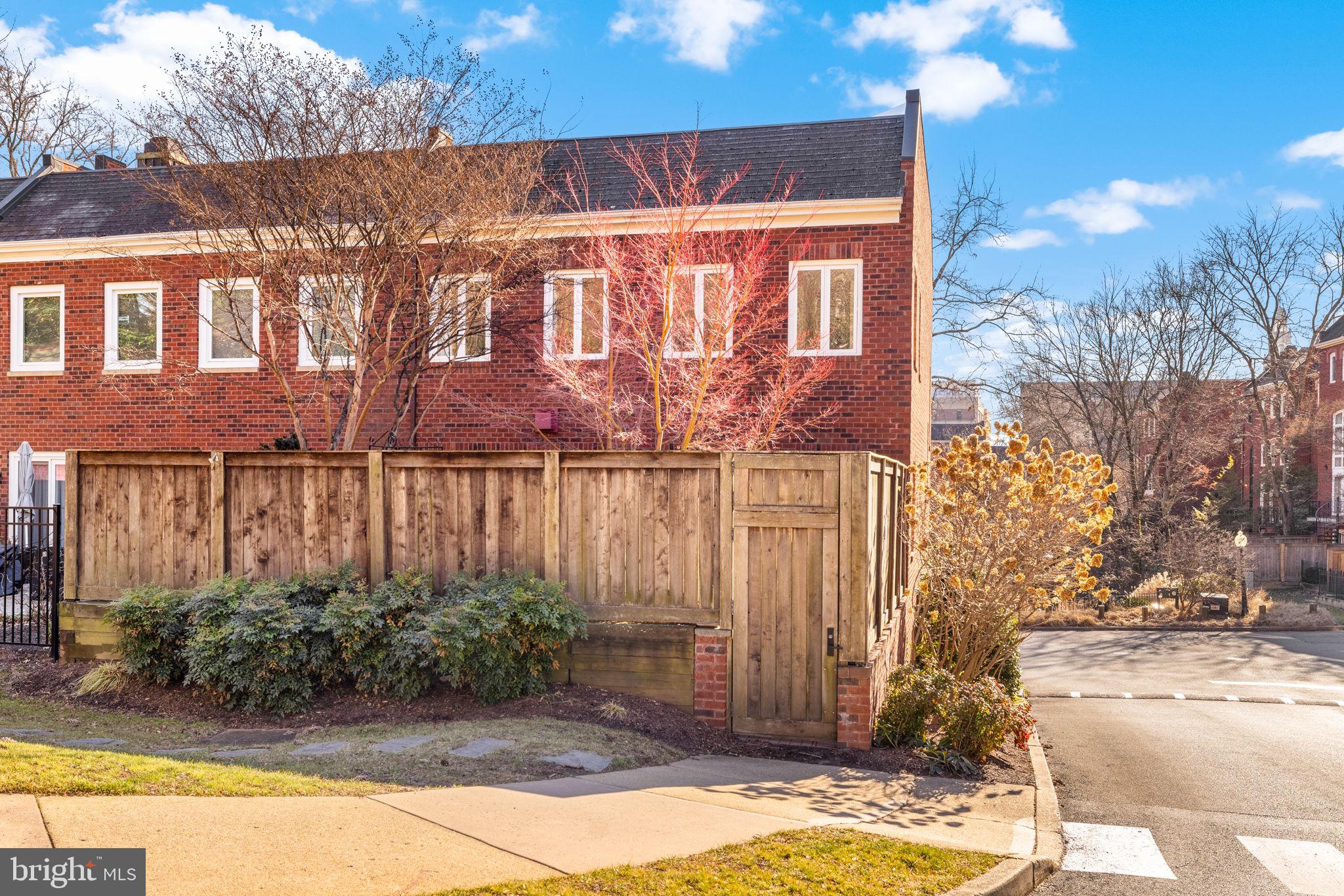 3988 Georgetown Court Northwest Washington, DC 20007 - Photo 38 of 38 a view of a brick house with a yard