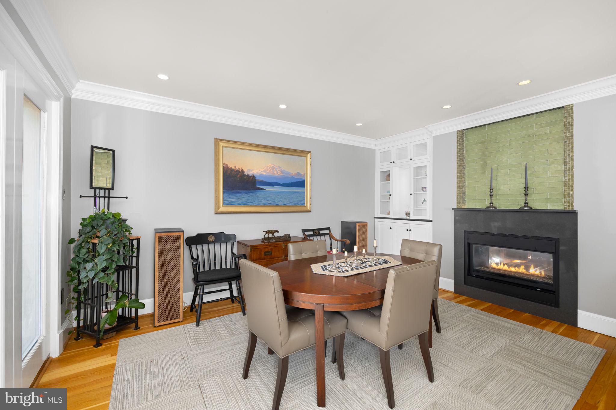 3988 Georgetown Court Northwest Washington, DC 20007 - Photo 9 of 38 a dining room with furniture and a fireplace