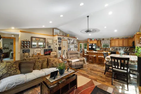 a living room with lots of furniture and kitchen view
