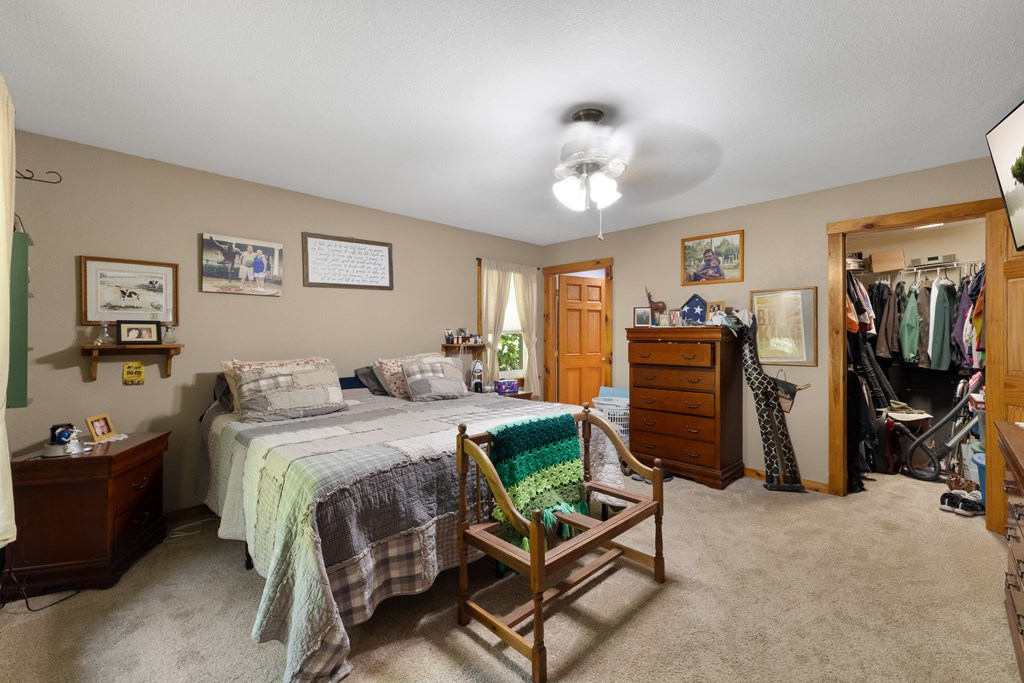 77 Chosen Ridge Morganton, GA 30560 - Photo 22 of 37 a bedroom with a bed and a chandelier