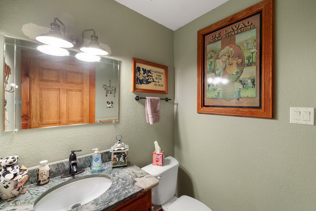 77 Chosen Ridge Morganton, GA 30560 - Photo 28 of 37 a bathroom with a granite countertop sink mirror and vanity
