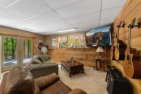 a living room with furniture a ceiling fan and a window