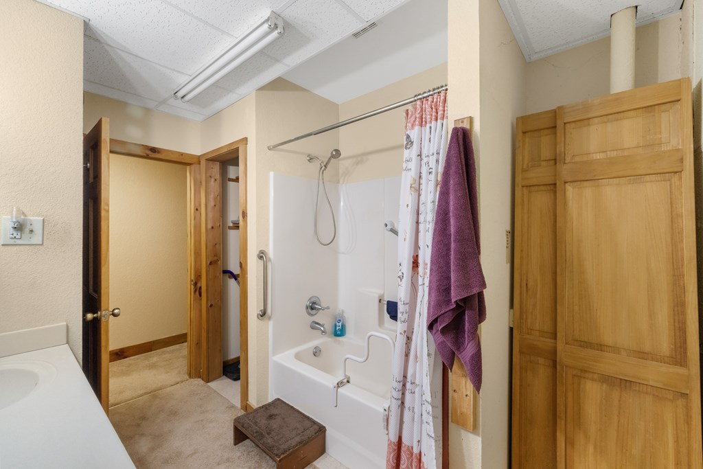 77 Chosen Ridge Morganton, GA 30560 - Photo 36 of 37 a bathroom with a tub shower and sink