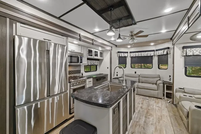 a kitchen with stainless steel appliances granite countertop a stove and a refrigerator