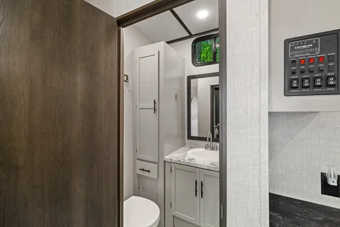 a bathroom with a toilet sink shower and mirror