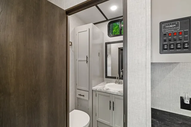 a bathroom with a toilet sink shower and mirror