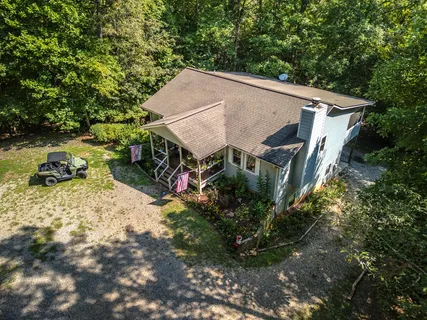 a aerial view of a house with yard and sitting area