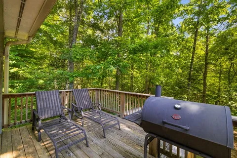 a view of a deck with two chair and wooden floor