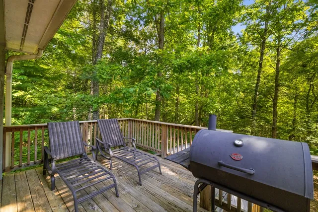 a view of a deck with two chair and wooden floor