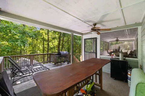 a view of a patio with a table chairs and a backyard