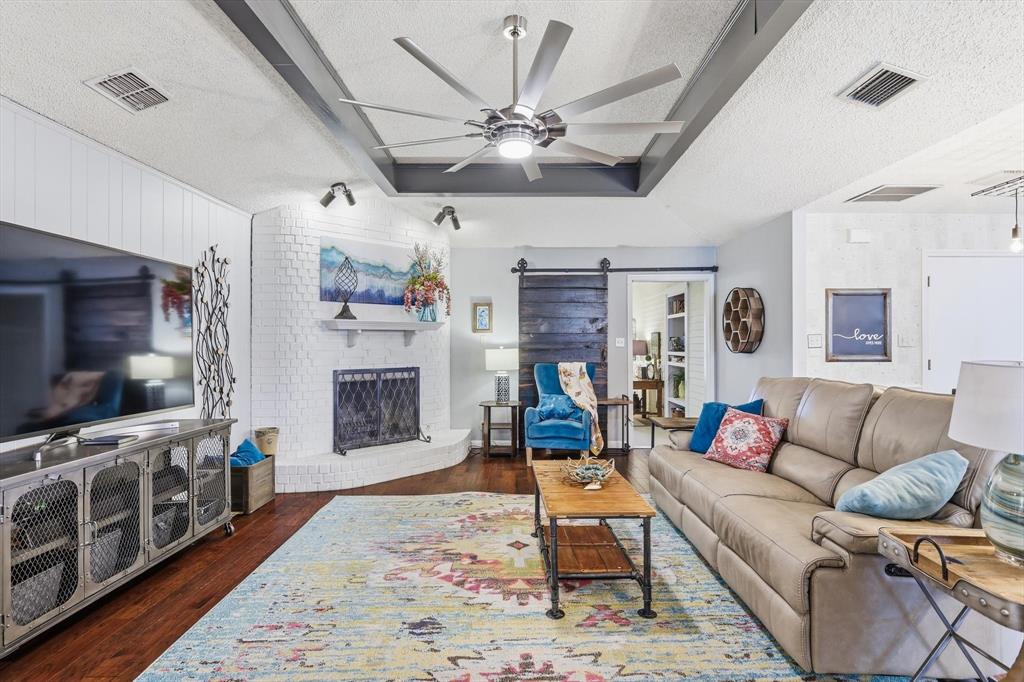 5301 Chinn Chapel Road Double Oak, TX 75028 - Photo 6 of 32 Beams on the ceiling and wood on the floor. Nice fireplace.