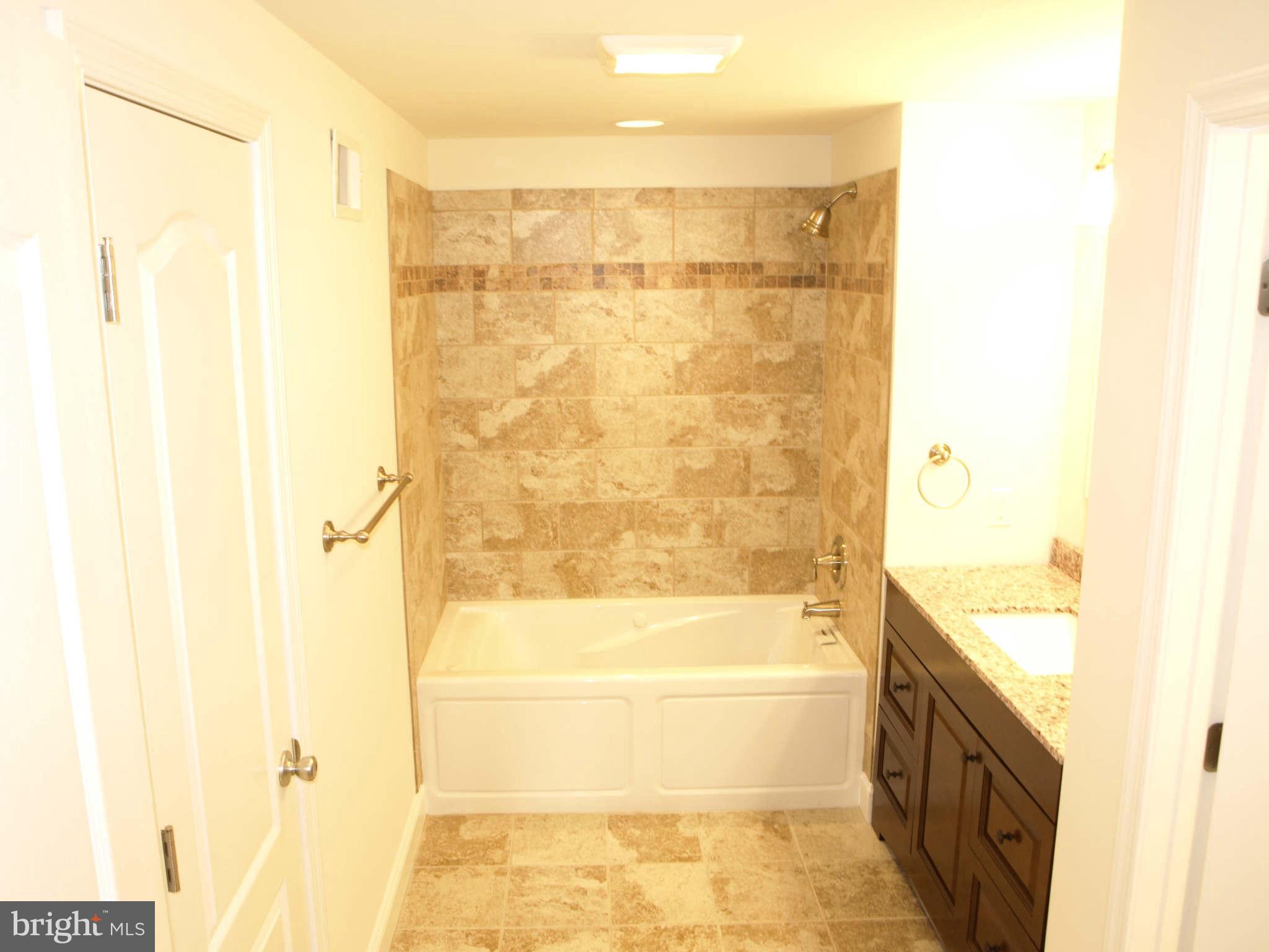 1500 Brian Road Baltimore, MD 21237 - Photo 3 of 30 a bathroom with a bathtub and a shower