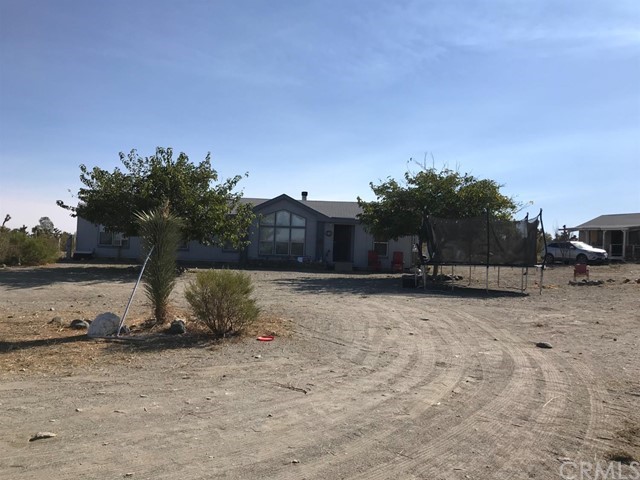 11623 Golden View Road Pinon Hills, CA 92372 - Photo 1 of 1 a backyard of a house with table and chairs