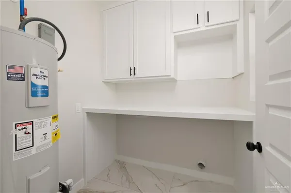 a white toilet sitting next to a white sink