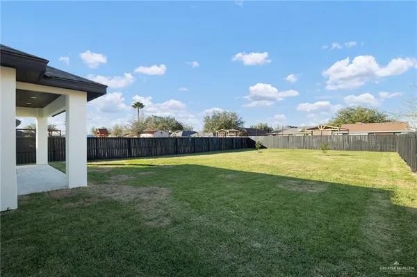 a view of a house with backyard and garden