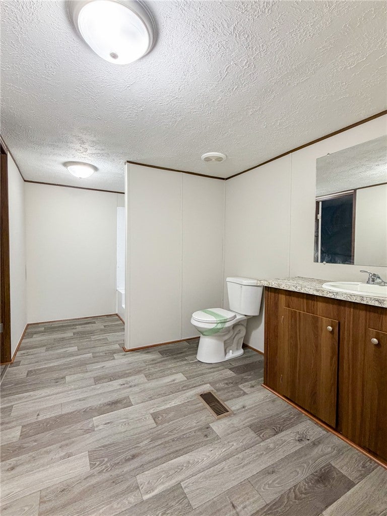 751 Ellis Road Shorter, AL 36075 - Photo 18 of 20 This bathroom features wood-look flooring and a functional vanity, perfect for daily routines.