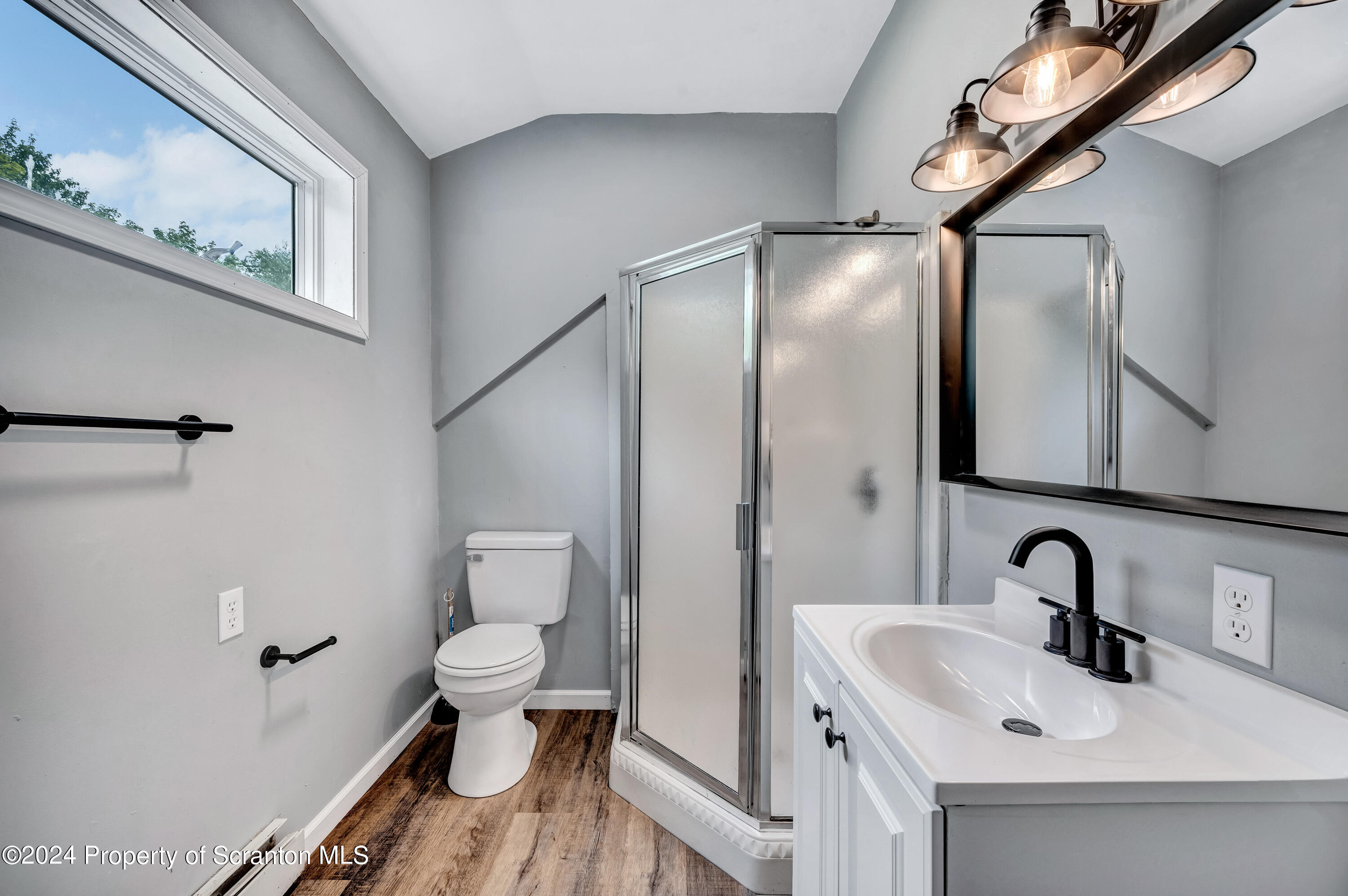 4579 Turnpike Road Montrose, PA 18801 - Photo 23 of 40 a bathroom with a sink a toilet and a mirror