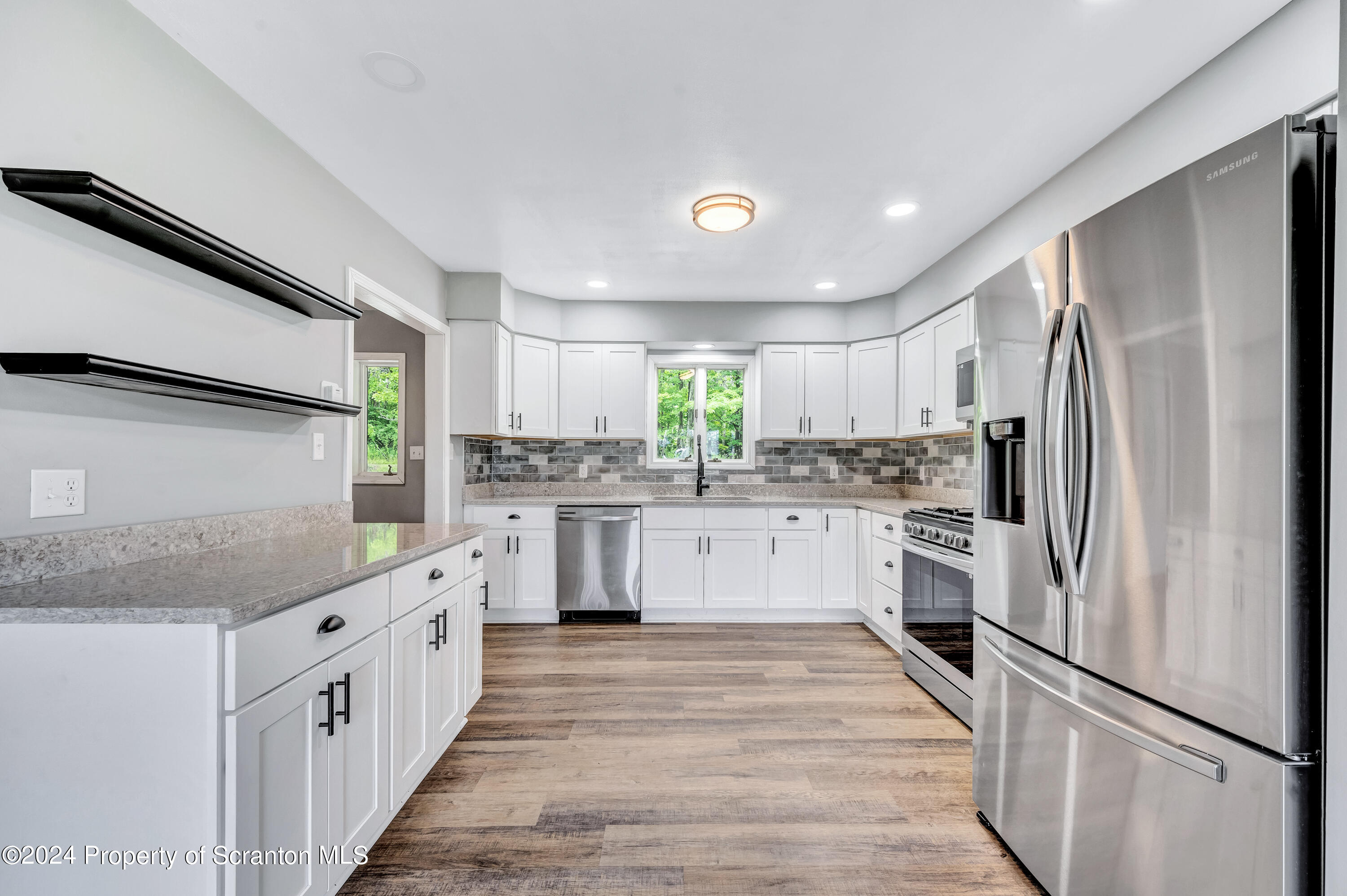 4579 Turnpike Road Montrose, PA 18801 - Photo 6 of 40 a kitchen with white cabinets and white appliances