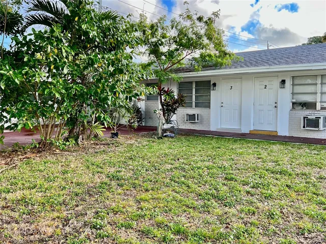 a backyard of a house with yard and outdoor seating